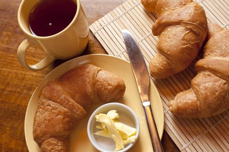 croissants and a mug of black espresso coffee